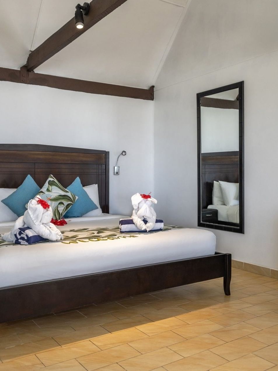 Comfortable Beach Front Bure room with a bed and amenities at Tambua Sands Beach Resort in Sigatoka.