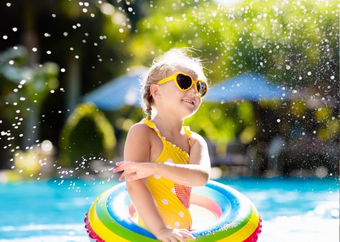 A girl playing in a swimming pool at Ogunquit Collection