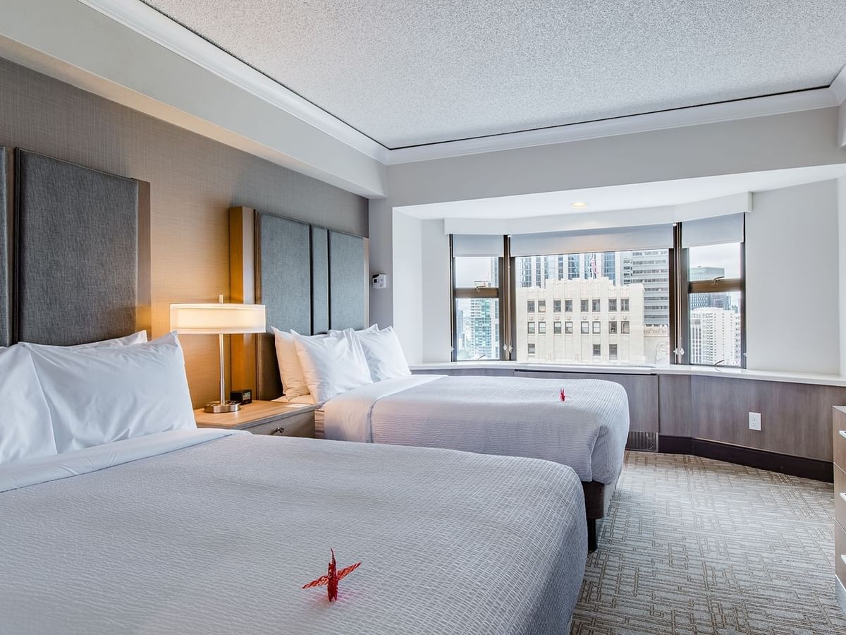 Hotel guestroom with two beds and a view of Seattle