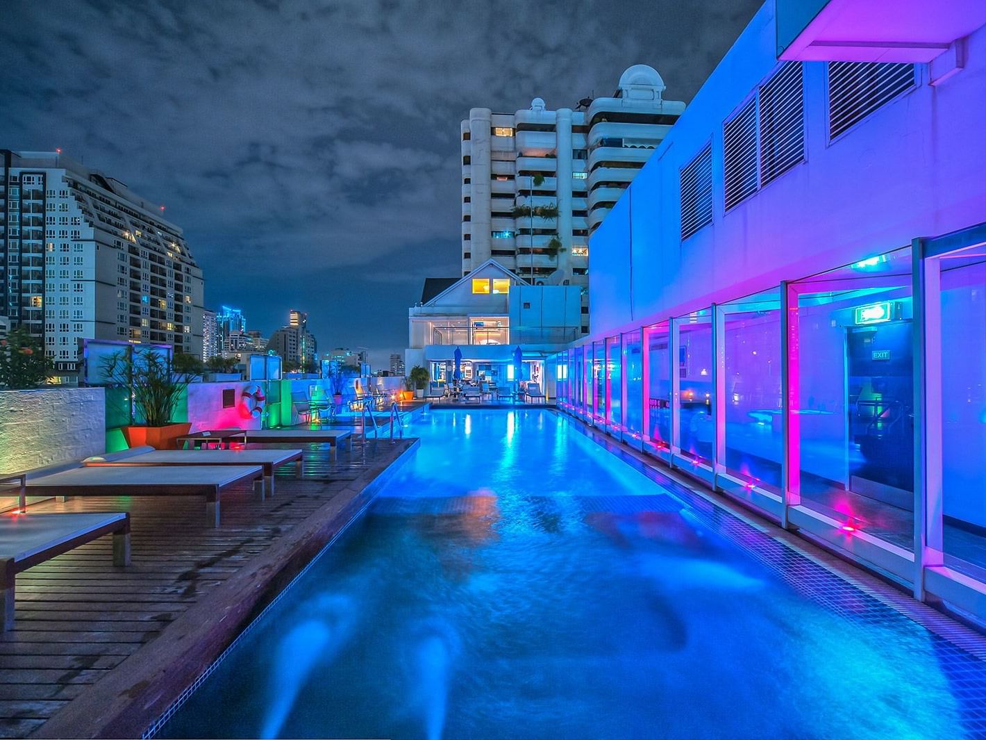 Roof top pool view with pool chairs at Dream Bangkok