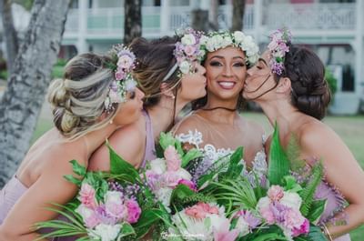 All the Bridesmaids kissing the bride at Bougainvillea Barbados