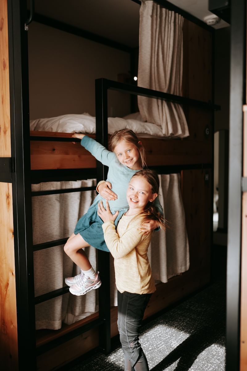 2 kids playing in Family Suite with a bunk bed, Kinship Landing