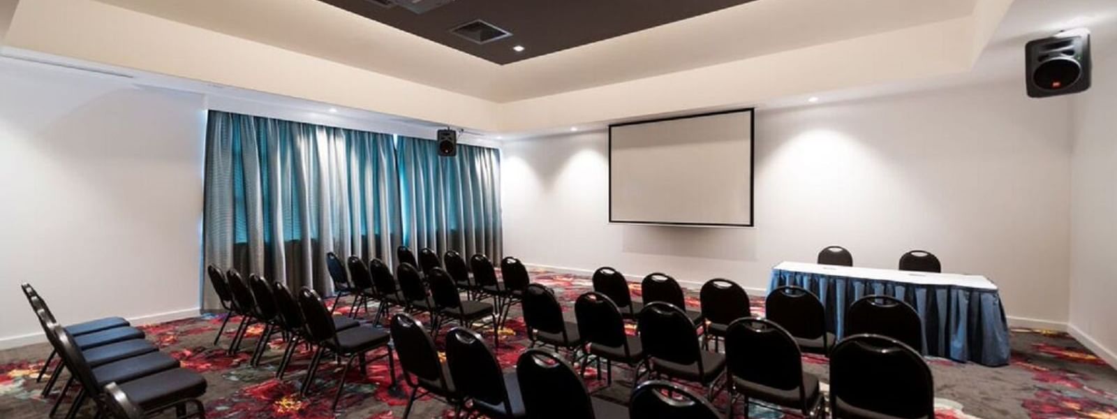 Table setup in Meeting hall with projector at Novotel Barossa