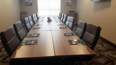 Boardroom table arrangement in a meeting room at Encore Suites Grande Prairie