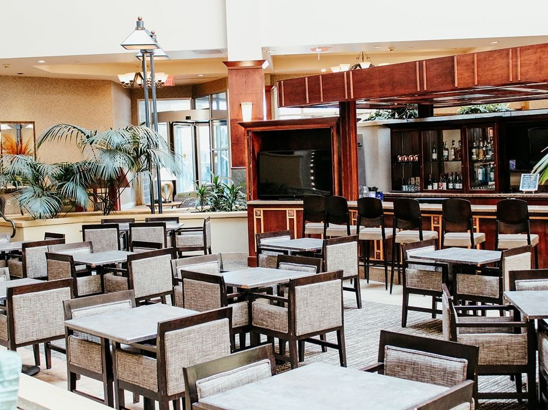 A large bar and seating area set in the atrium of Hotel Topeka at City Center