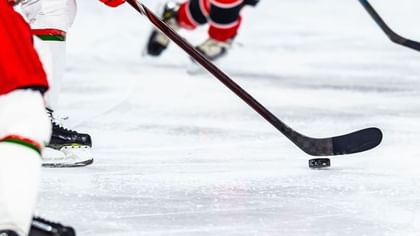 Hockey players with red uniforms and sticks on ice by the rink near Warwick Le Crystal Montreal