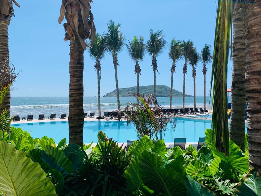Outdoor family pool with sunbeds at Viaggio Resort Mazatlan