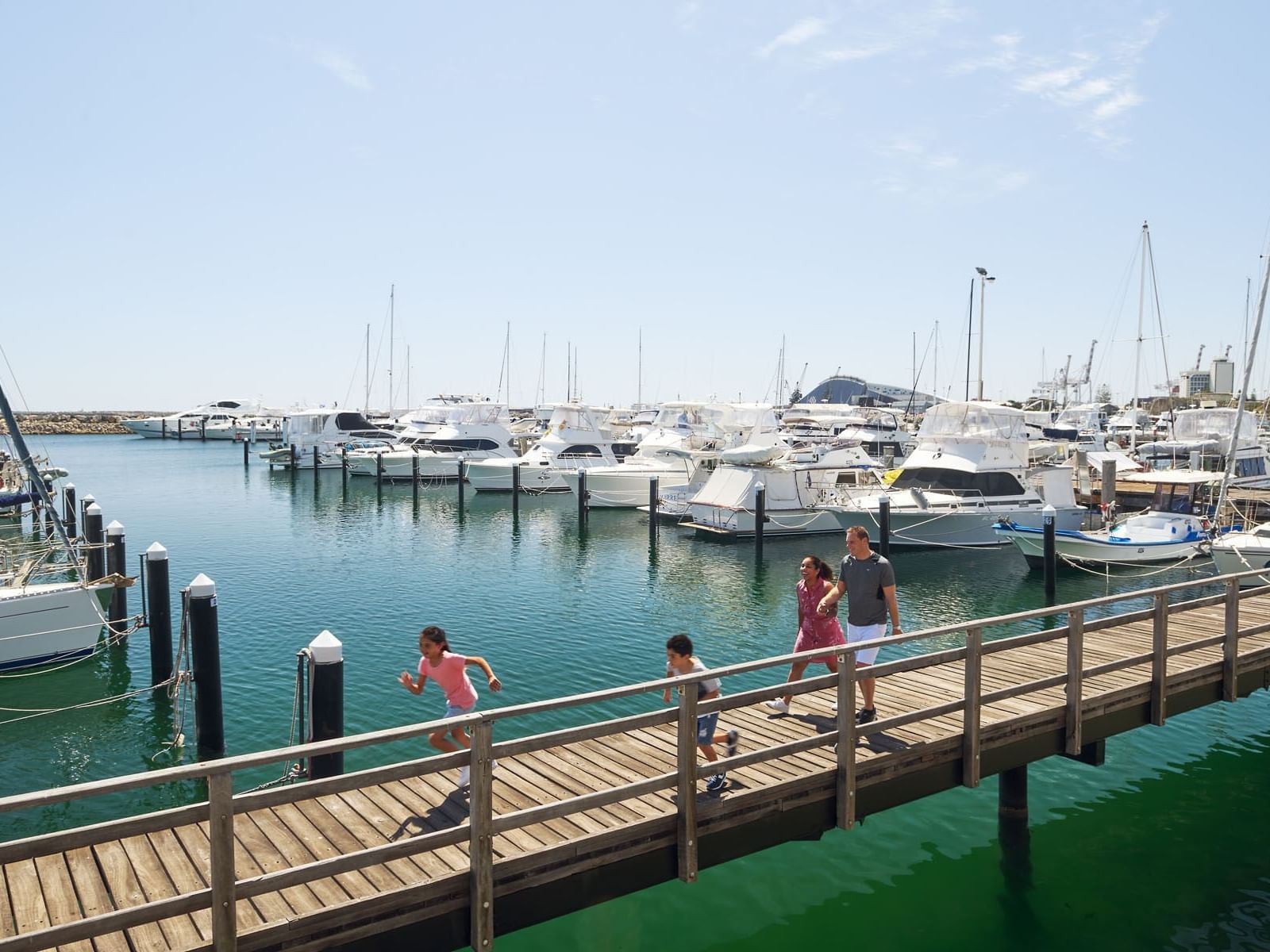 A family at the pier by the beach near Be Fremantle