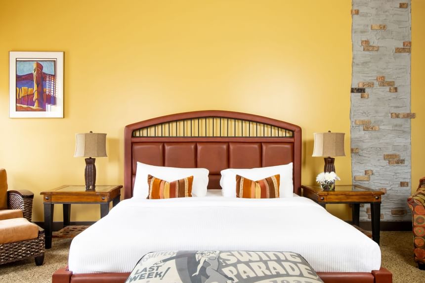 King bed with comfy pillows in King Premiere Sante Fe at Retro Suites Hotel