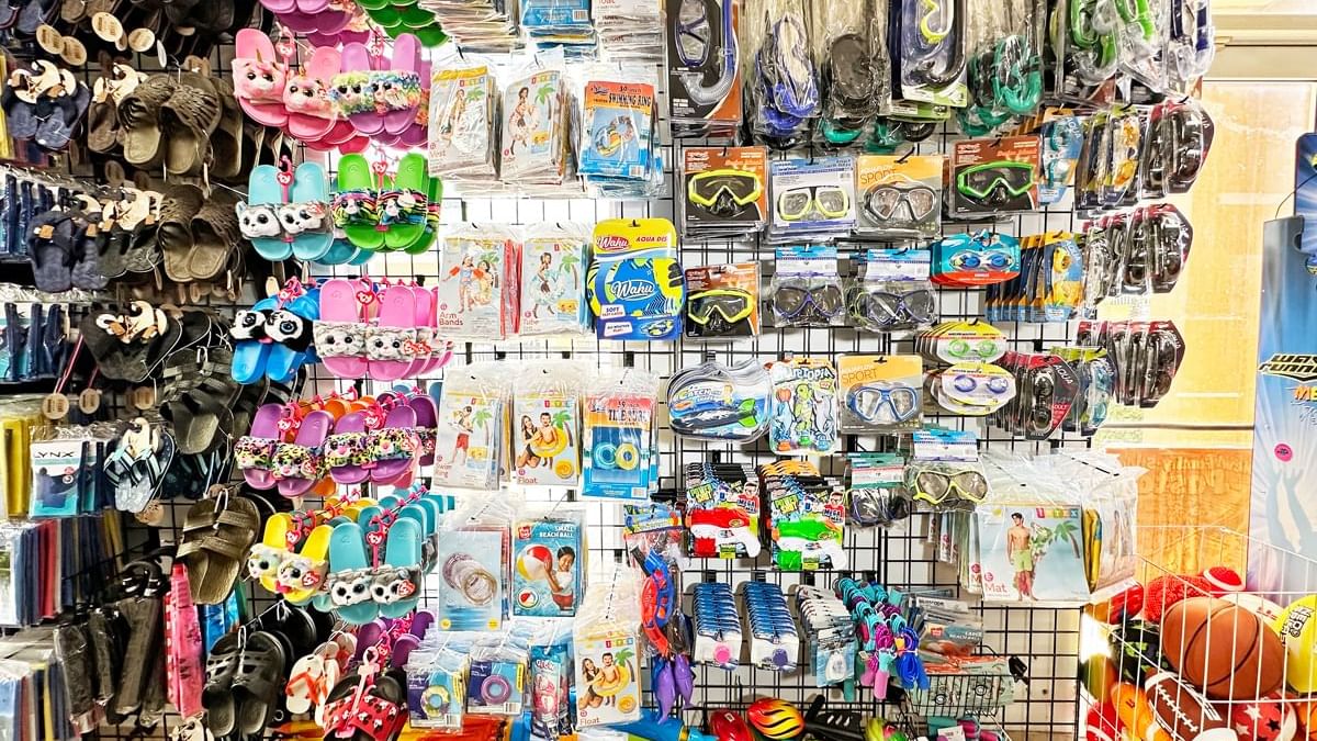 a store shelf filled with various items including swimwear, goggles, and toys