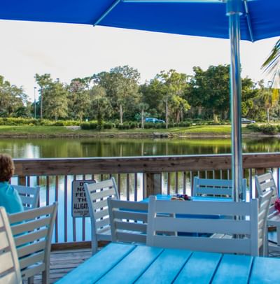 Outdoor dining & lounge area with Lake view at Trianon Bonita Bay