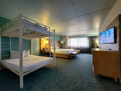 King Family Suite at Margaritaville Resort Biloxi, featuring a large bed and a cozy set of bunk beds