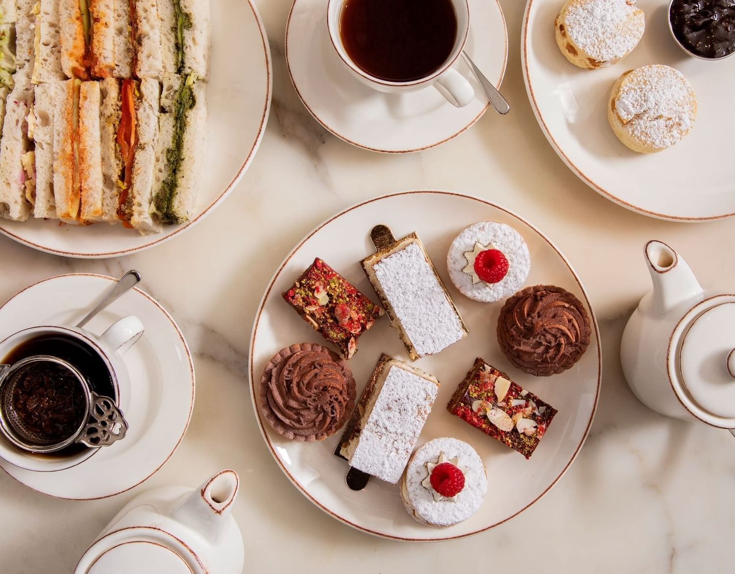 Afternoon Tea with sandwiches and cakes served in May Fair Kitchen at The May Fair Hotel