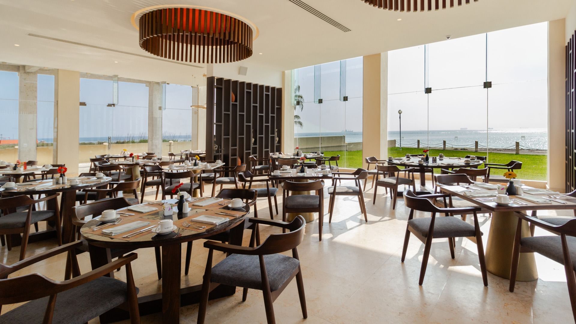 La Huerta seaside dining with large windows overlooking the bright blue sea at Camino Real Veracruz