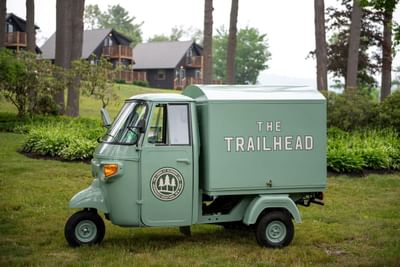 Trailhead Vintage Truck with beverages parked on grass in The Lodge at Schroon Lake