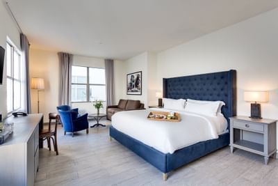 Bedroom & living area in Deluxe King at Clinton Hotel South 