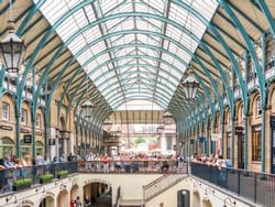 Covent Garden with people standing by the rail near St. Giles