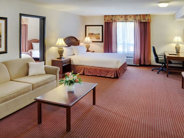 Grimshaw hotel room with seating area and bed