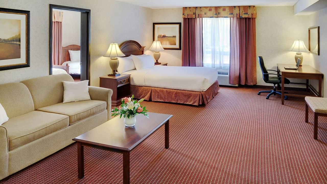 Grimshaw hotel room with seating area and bed