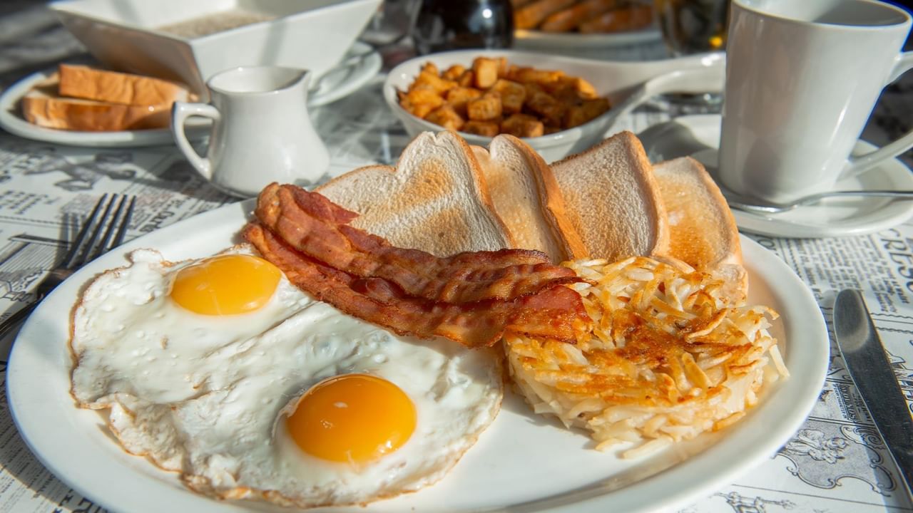 Plate with eggs, bacon, and hash browns.