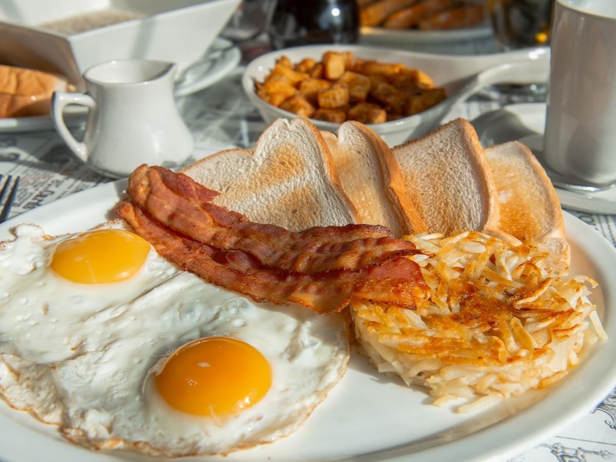 Plate with eggs, bacon, and hash browns at Sam’s Friends Kitchen.