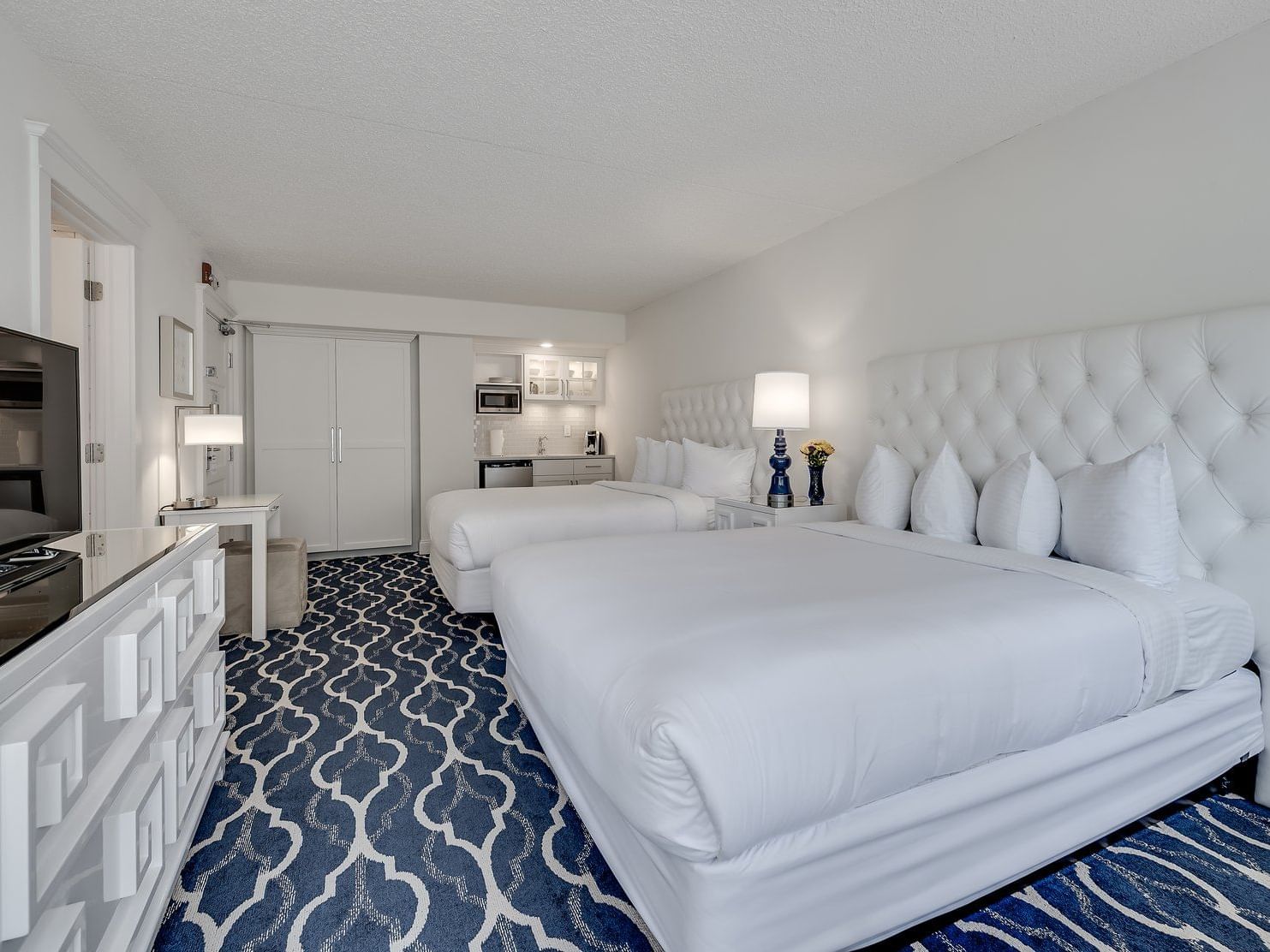 room with two all white beds