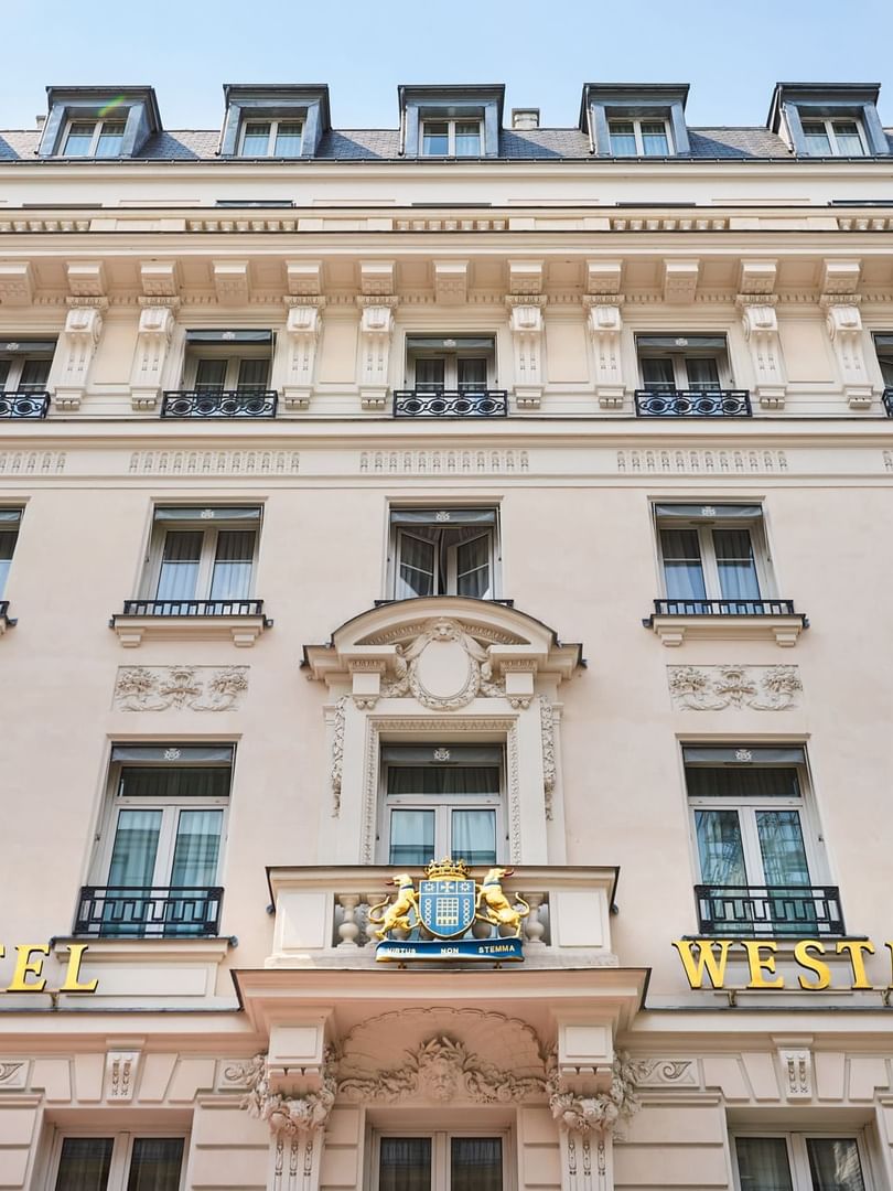 Low-angle exterior view of Hotel Westminster Paris facade with gold signage