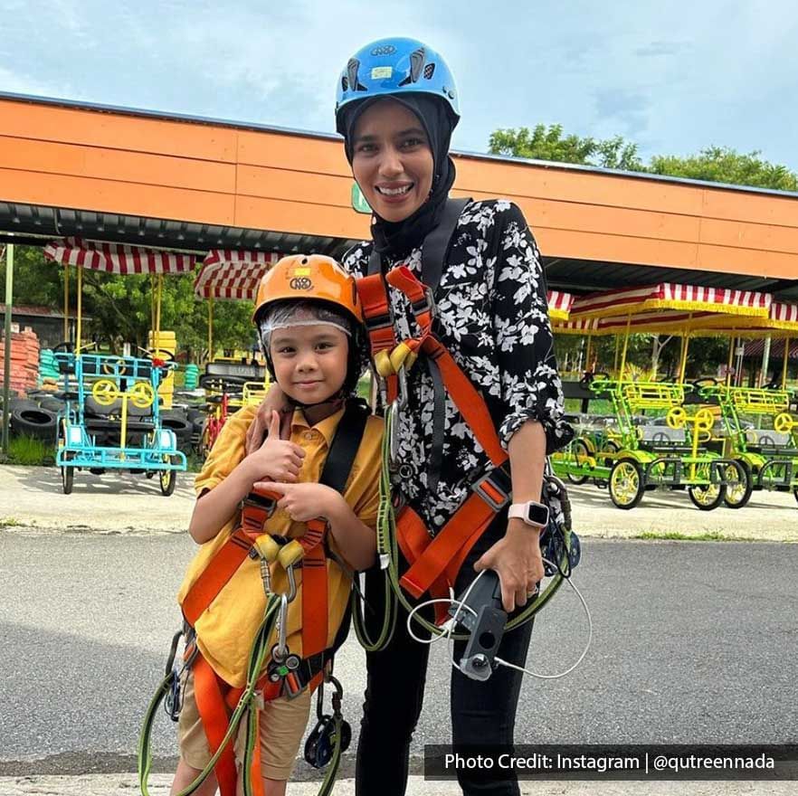 Two people in helmets and harnesses ready for outdoor activity - Lexis Port Dickson