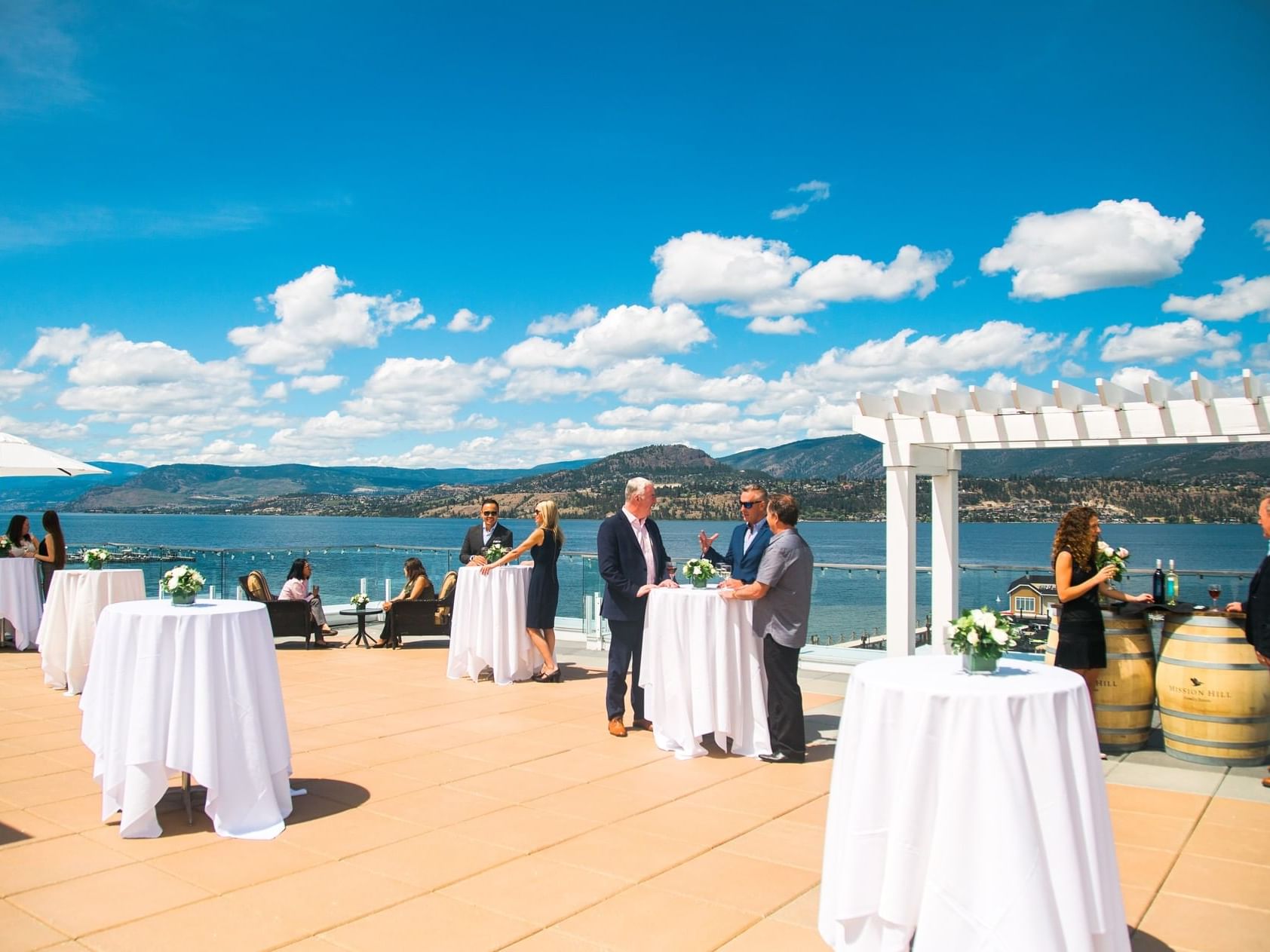 Guests around cocktail tables at Manteo Resort Waterfront