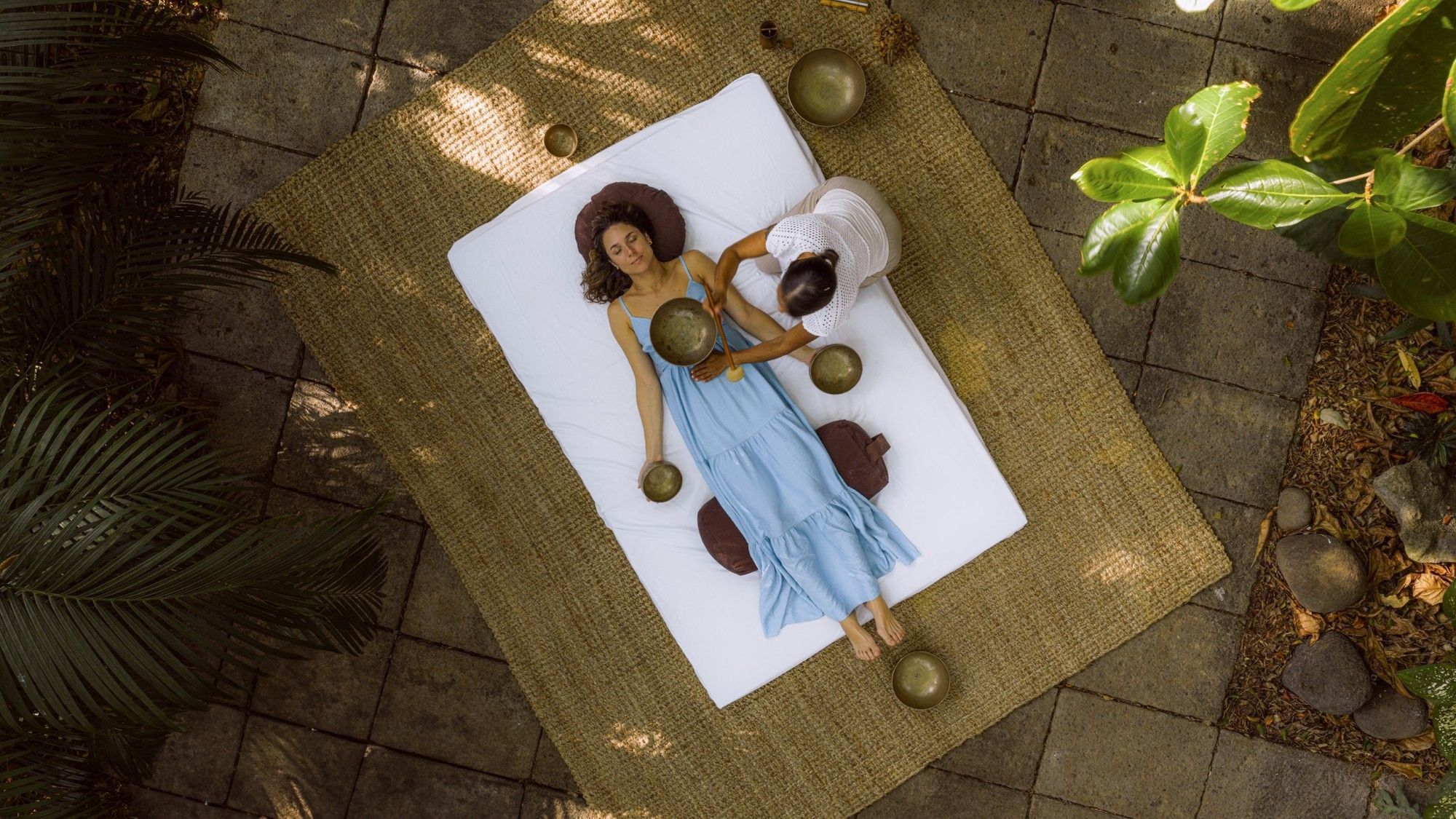 Bird’s-eye view of a sound therapy session set on a in Lahari Wellness Center patio at Cala Luna Boutique Hotel