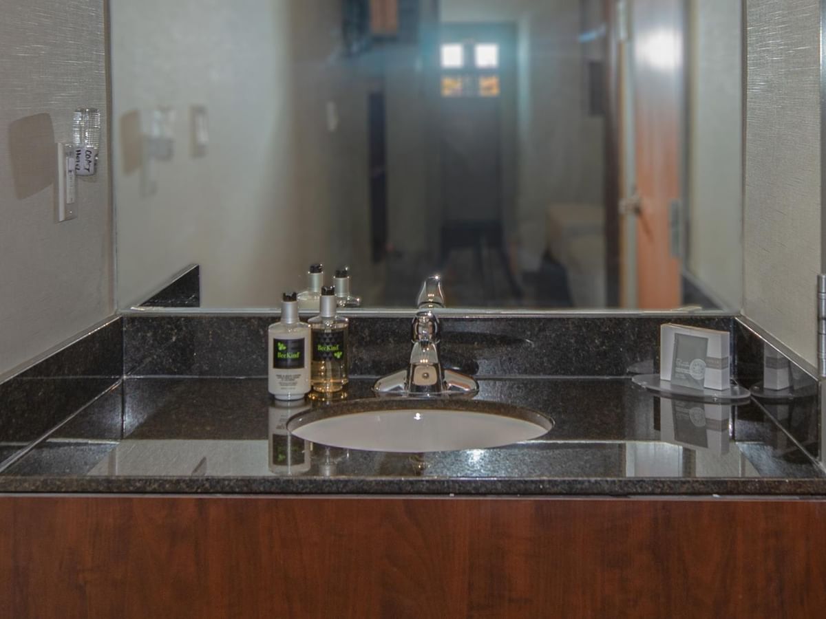 Bathroom sink with countertop and mirror.