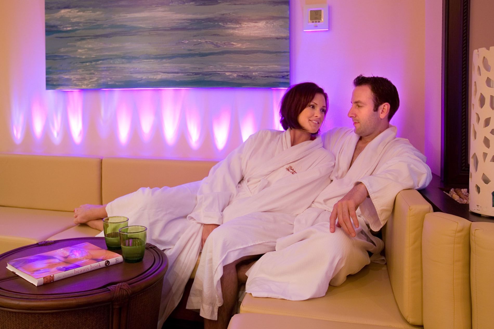Couple lounging on a sofa in Reflections Spa & Salon at Lake Buena Vista Resort Village & Spa