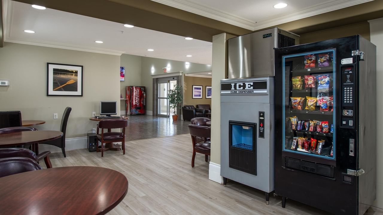 Modern hotel lobby with vending machines, seating areas, and light wood flooring at Coast Edson Hotel