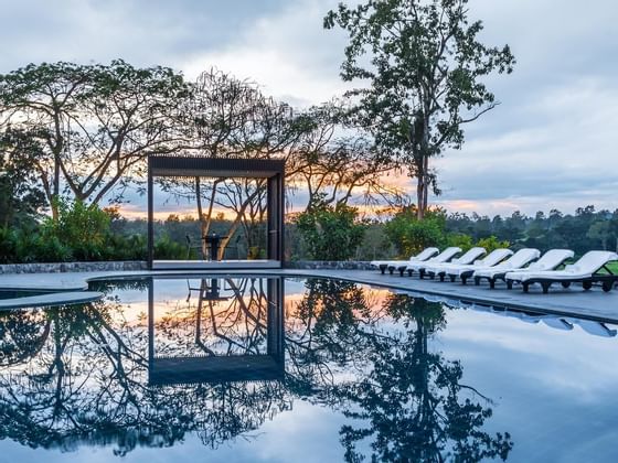 Sunbeds by Outdoor Pool at Chatrium Hotels & Residences