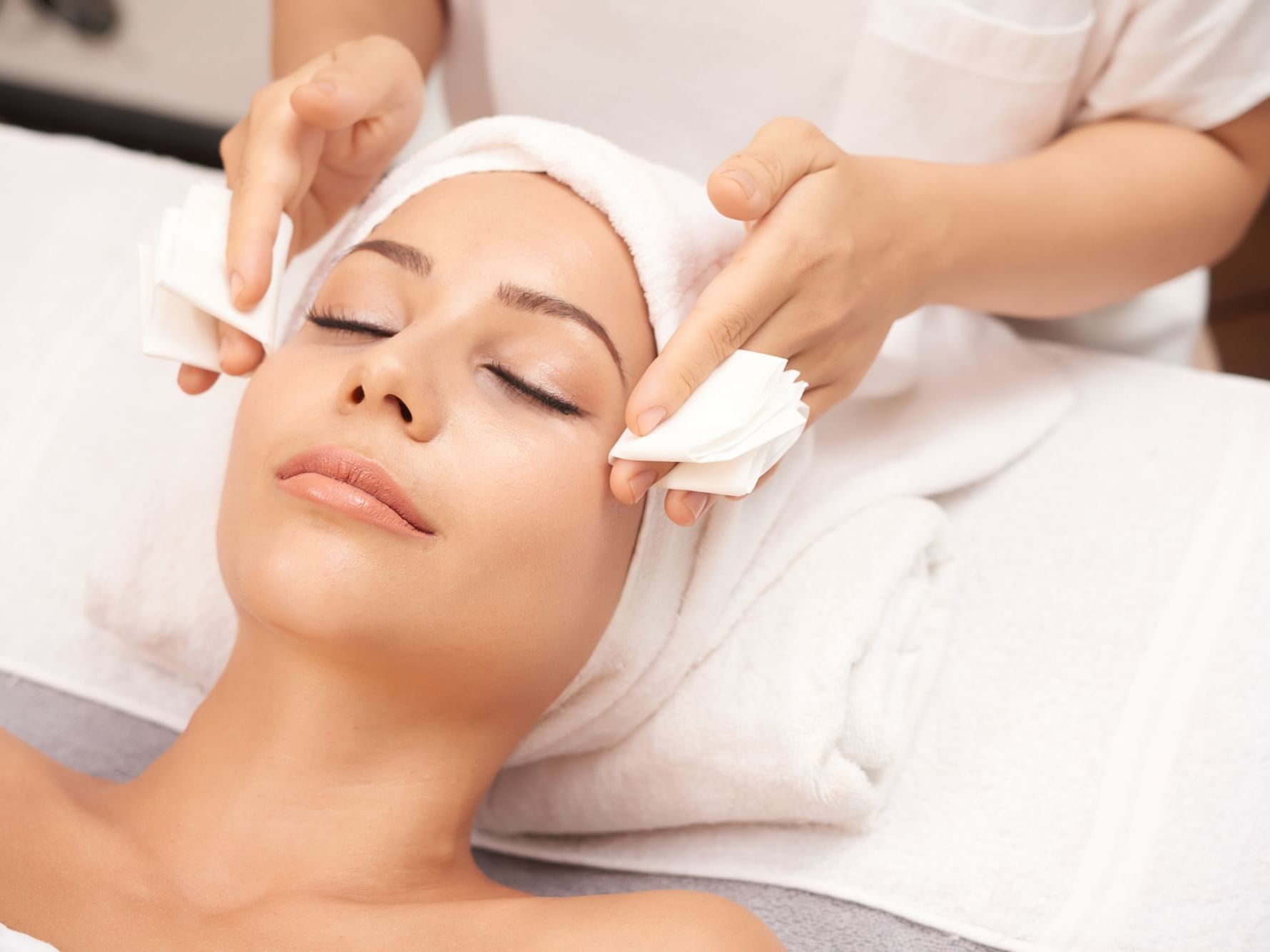 A woman receiving a facial at the Spa in Manteo Resort