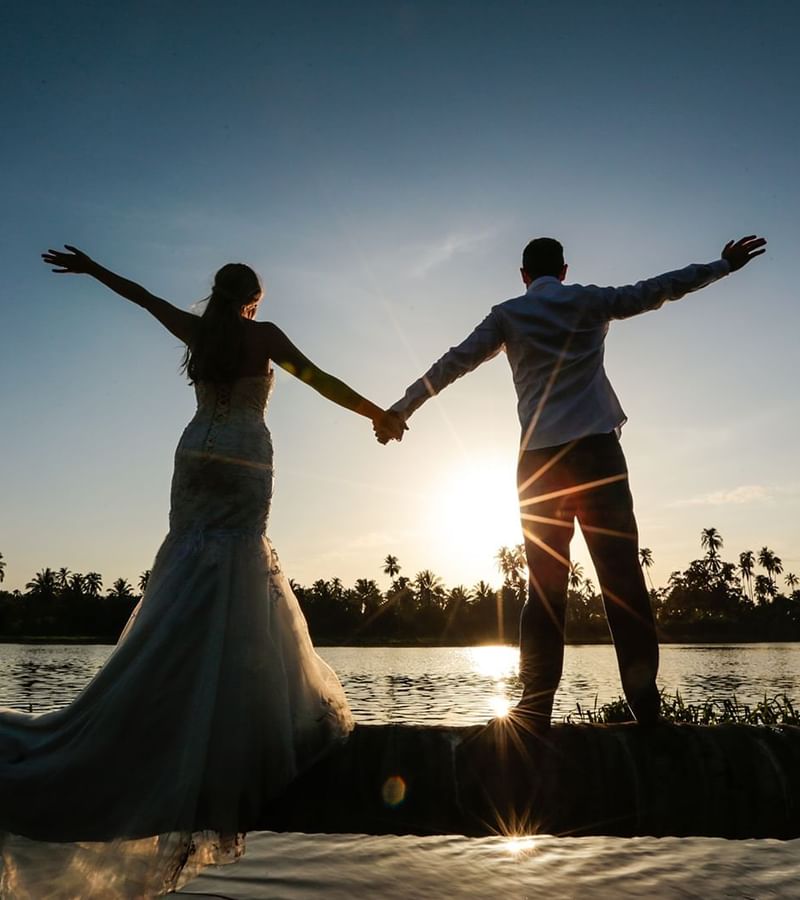 Bride & groom posing at sunset near Mundo Imperial