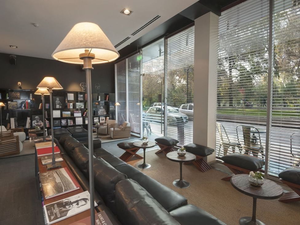 Stand lamps, wood tables, and sofas in Hotel Ismael