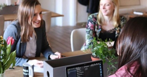 Small group of women collaborate in a workspace