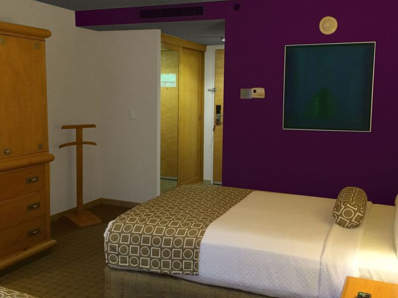 King bed & closet in Executive Room at Gamma Hotels