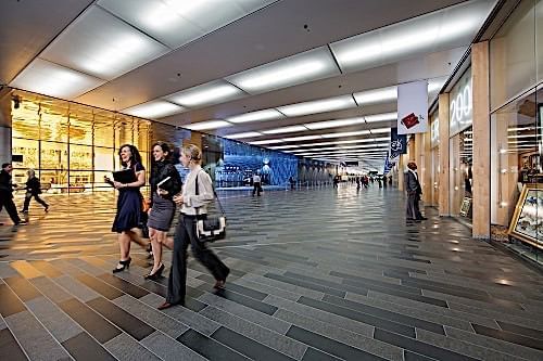 women walking through large hallway