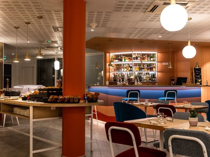 Interior of a bar with dining tables at Originals Hotel