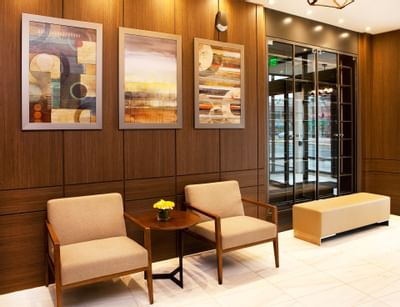 paintings hanging above chairs in a hotel