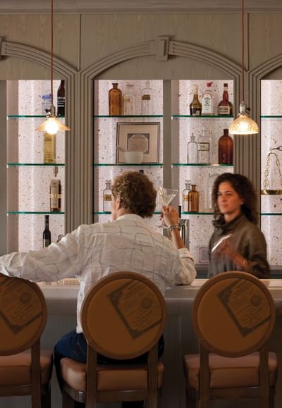 Man enjoying a cocktail by the bar counter, Hotel Parq Central