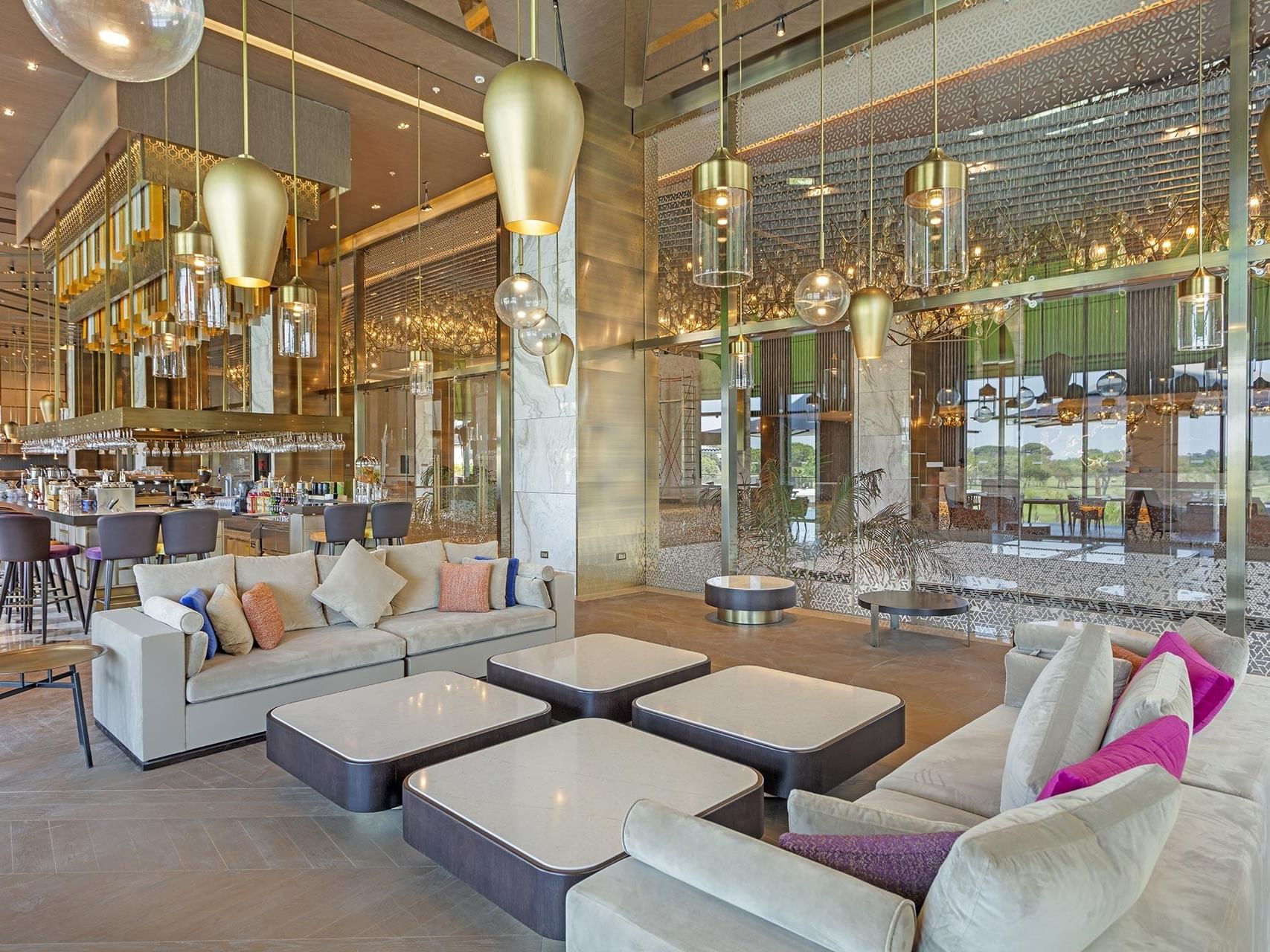 Dining area with cozy sofa setup in Cordelia Lobby Bar at Cullinan Belek