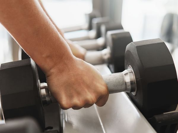 hands and dumbbell