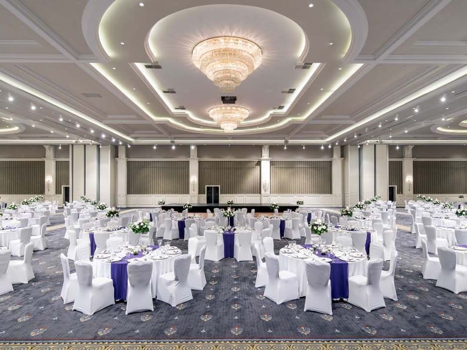 Banquets arranged with cozy white chairs in Pacific Ballroom at Titanic Deluxe Golf Belek