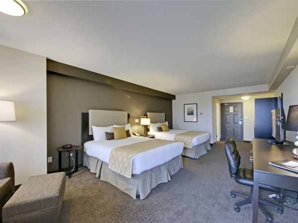 Two beds and desk in hotel room