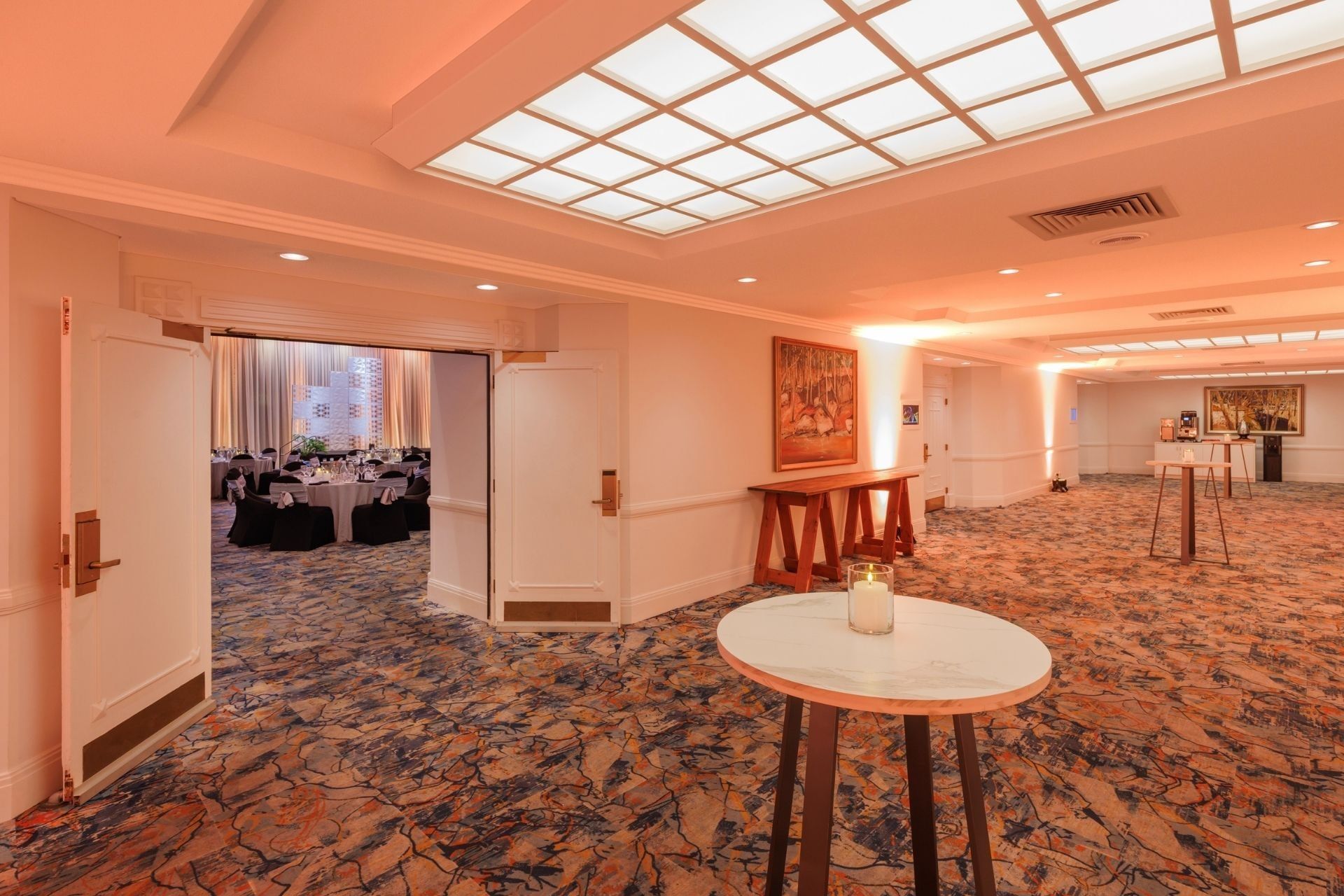 Elegantly decorated pre-function with tables and chairs at Hotel Grand Chancellor Adelaide