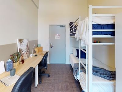 Bunk Room Twin Share with two bunk beds and two desks at UniLodge Herston.