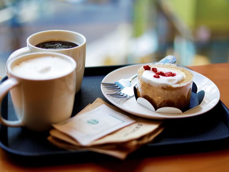 Close-up of coffee & a cupcake served at Fiesta Inn Hotels